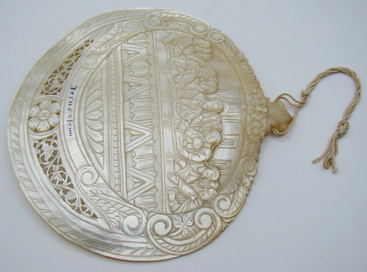 Reverse of mother-of-pearl Last Supper shell showing curved surface and pierced ornament