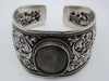 Silver floral cuff bracelet on a digital scale displaying total weight of 54.7 grams