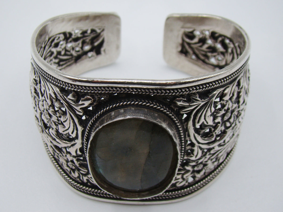 Silver floral cuff bracelet on a digital scale displaying total weight of 54.7 grams