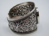 Front view of 925 silver cuff bracelet with oval centrepiece, floral openwork and rope-like borders