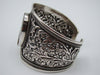 Interior view of silver cuff showing the 925 stamp, openwork and reverse of the centre setting