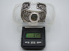 Rear view of open-backed silver cuff showing finished terminals and interior surface wear