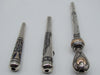 End view showing openings and contrasting decoration on three silver mouthpieces
