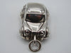 Front view of silver miniature car pendant showing grille and headlights