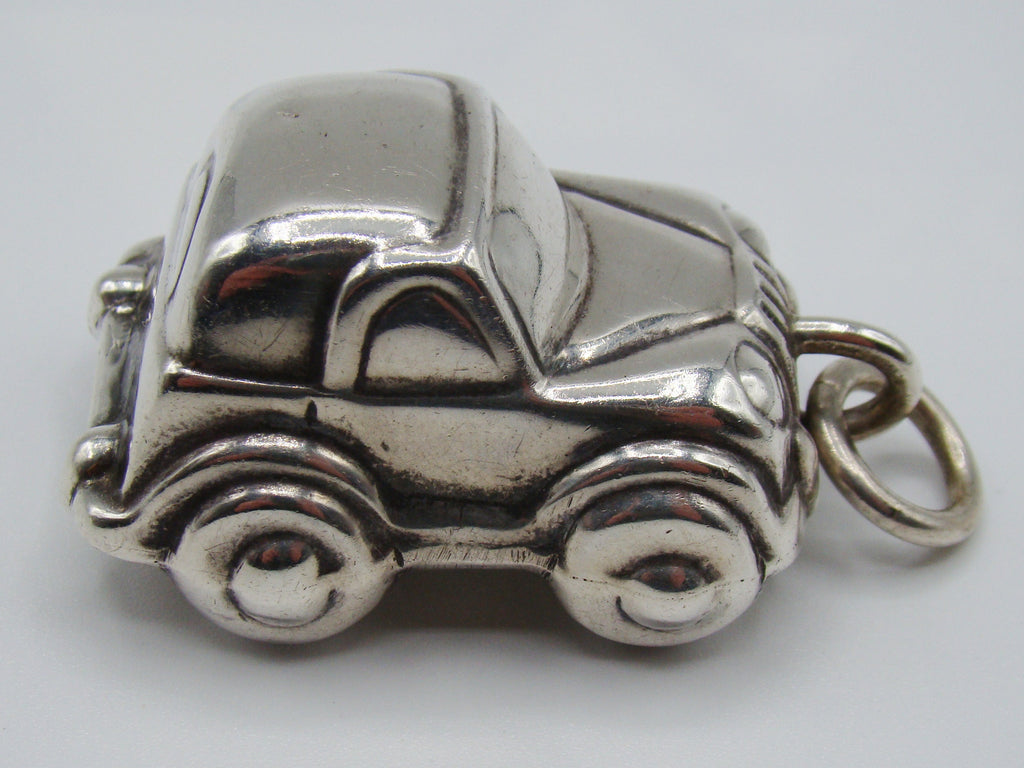 Side view of 925 sterling silver miniature car pendant with suspension ring