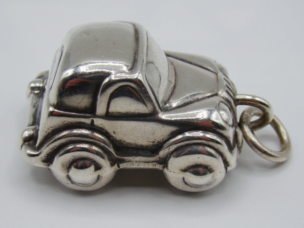 Side view of 925 sterling silver miniature car pendant with suspension ring