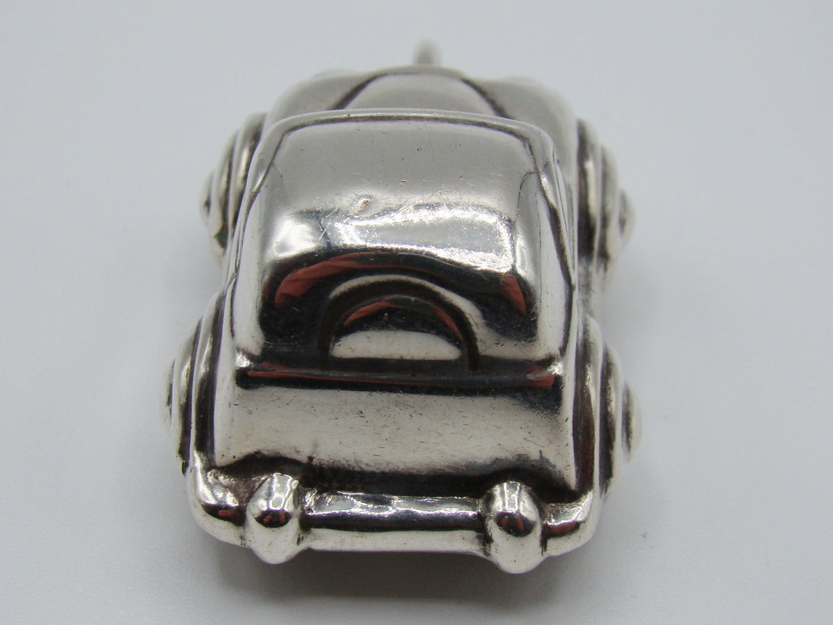 Elevated front view of sterling silver miniature car and suspension ring