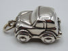 Opposite side of silver miniature car showing windows and wheel arches