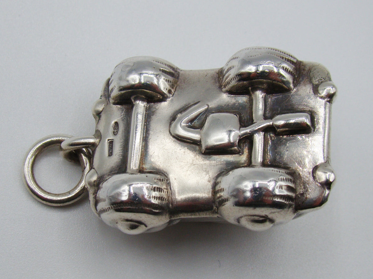 Underside of silver miniature car showing 925 stamp and additional mark