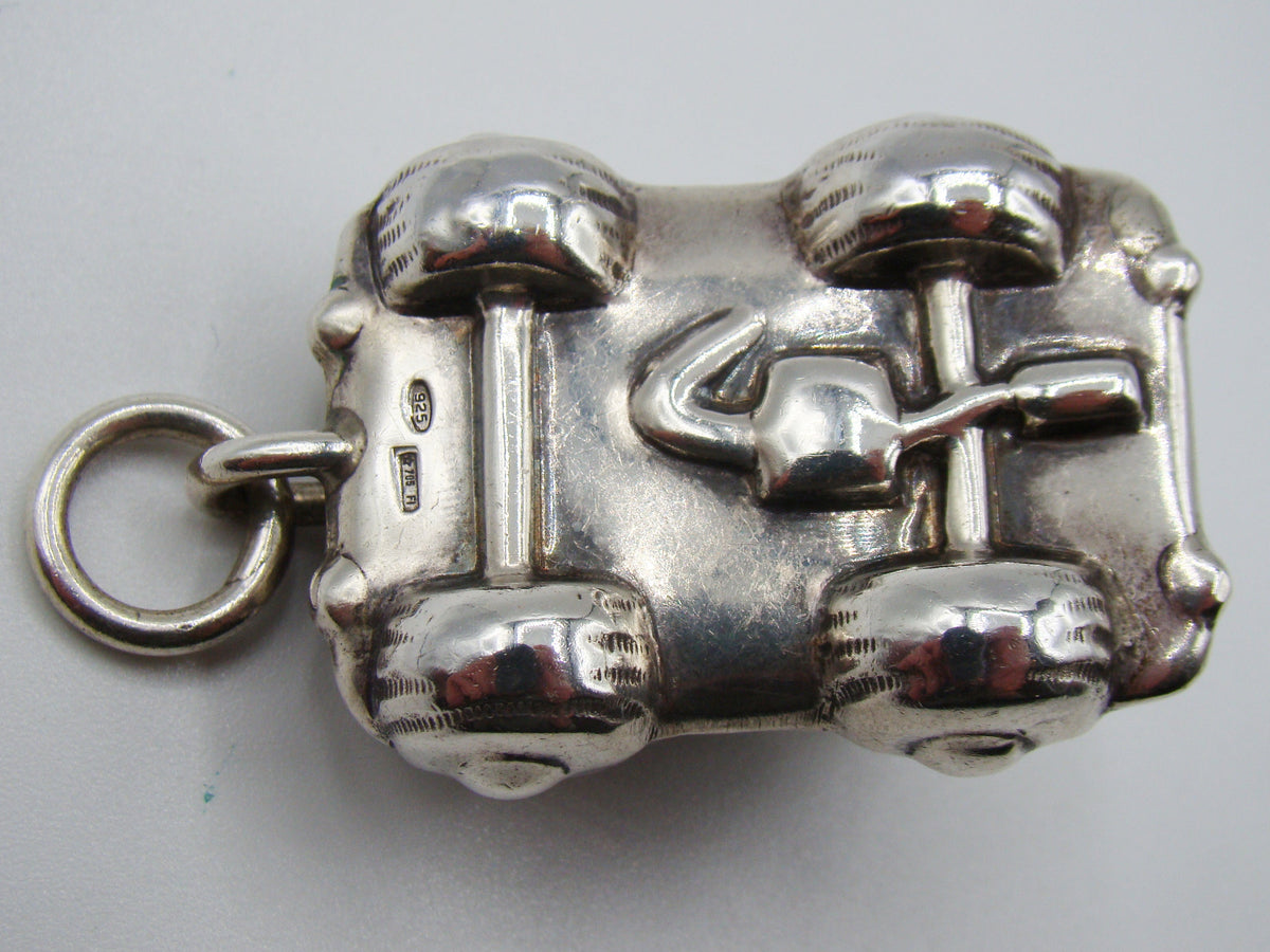 Close view of underside and 925 fineness mark on miniature silver car