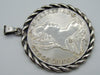 Angled portrait-side view of Maria Theresa silver coin pendant