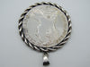 Close view of portrait and twisted frame on Maria Theresa coin pendant