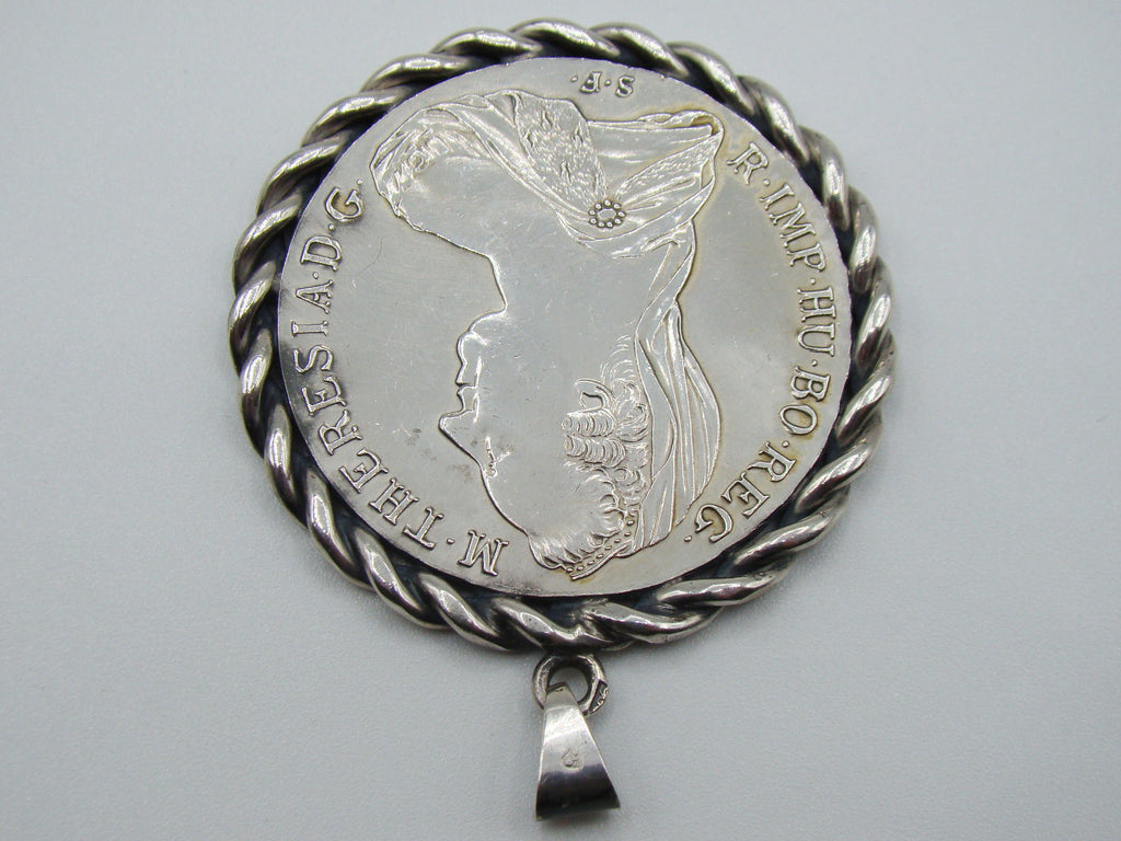 Close view of portrait and twisted frame on Maria Theresa coin pendant
