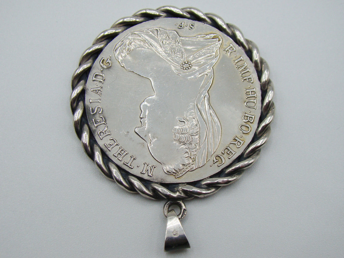 Close view of portrait and twisted frame on Maria Theresa coin pendant