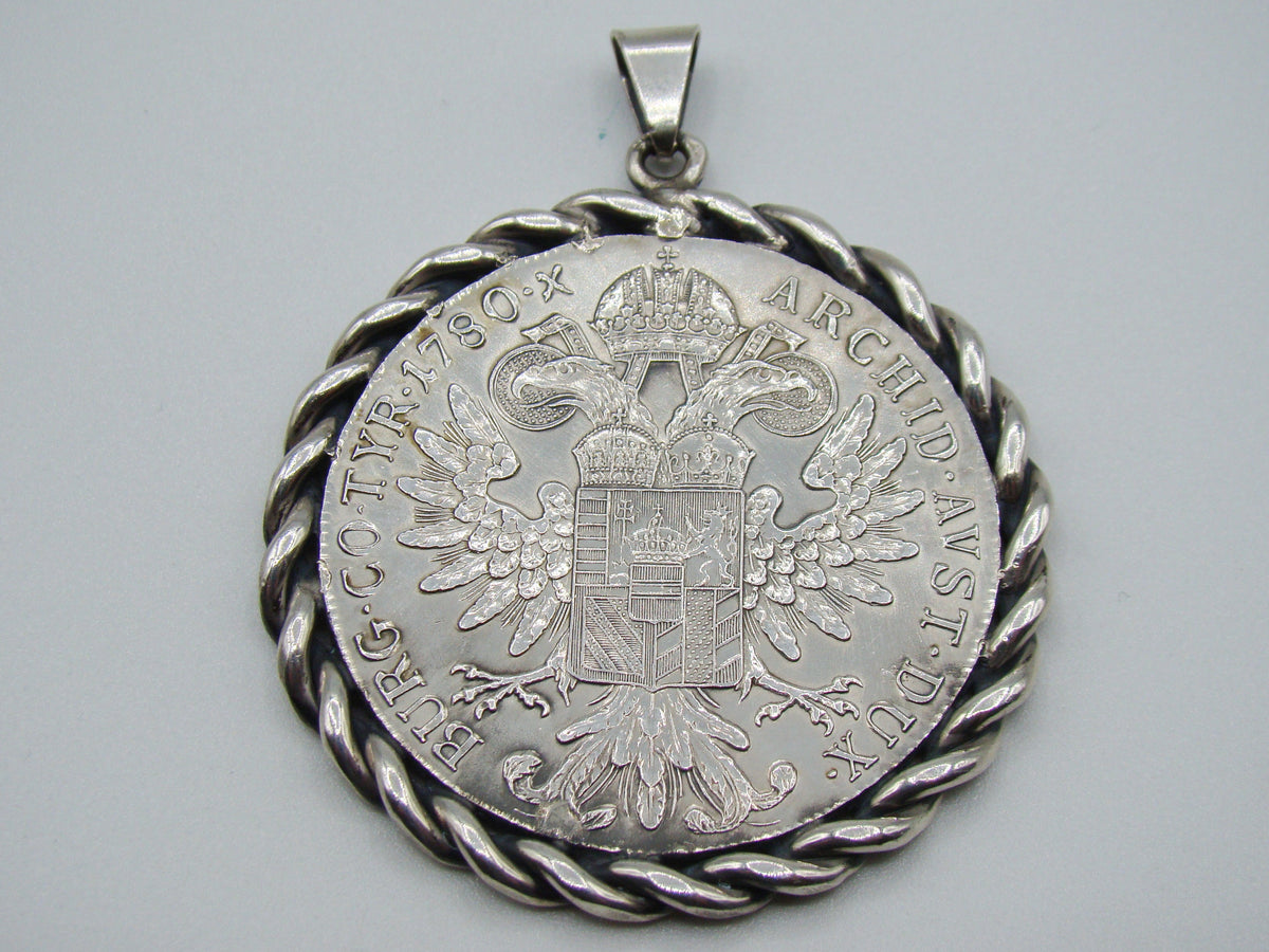 Reverse of Maria Theresa coin pendant showing double-headed eagle and date 1780