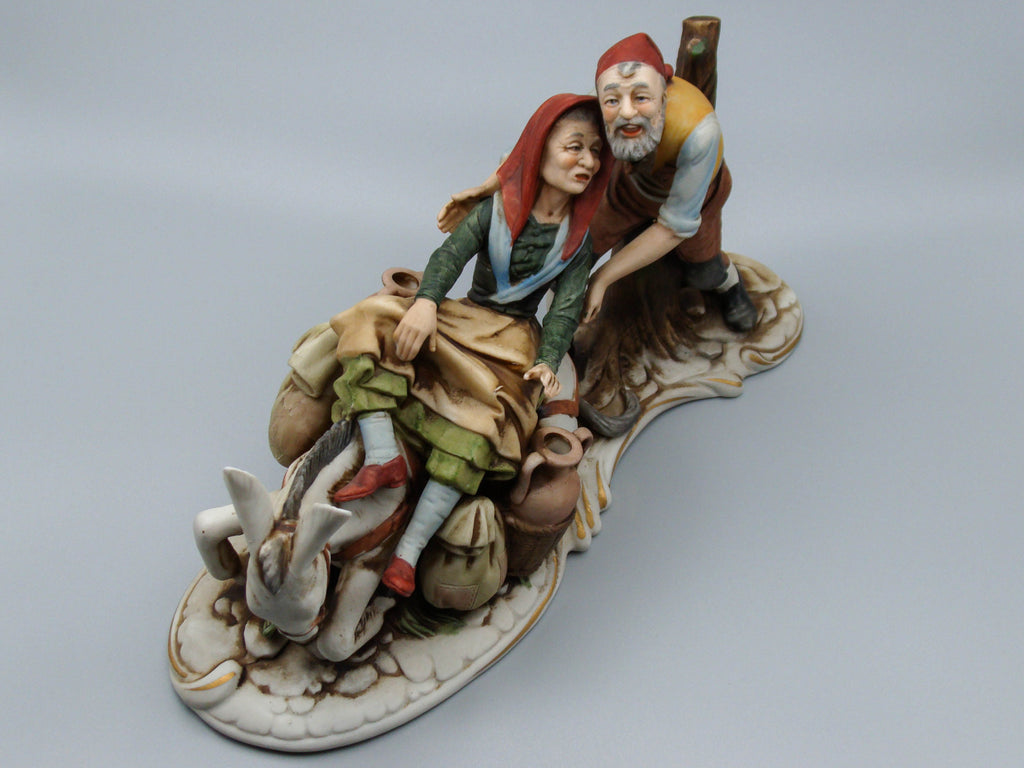 Merchant pair with donkey porcelain figurine