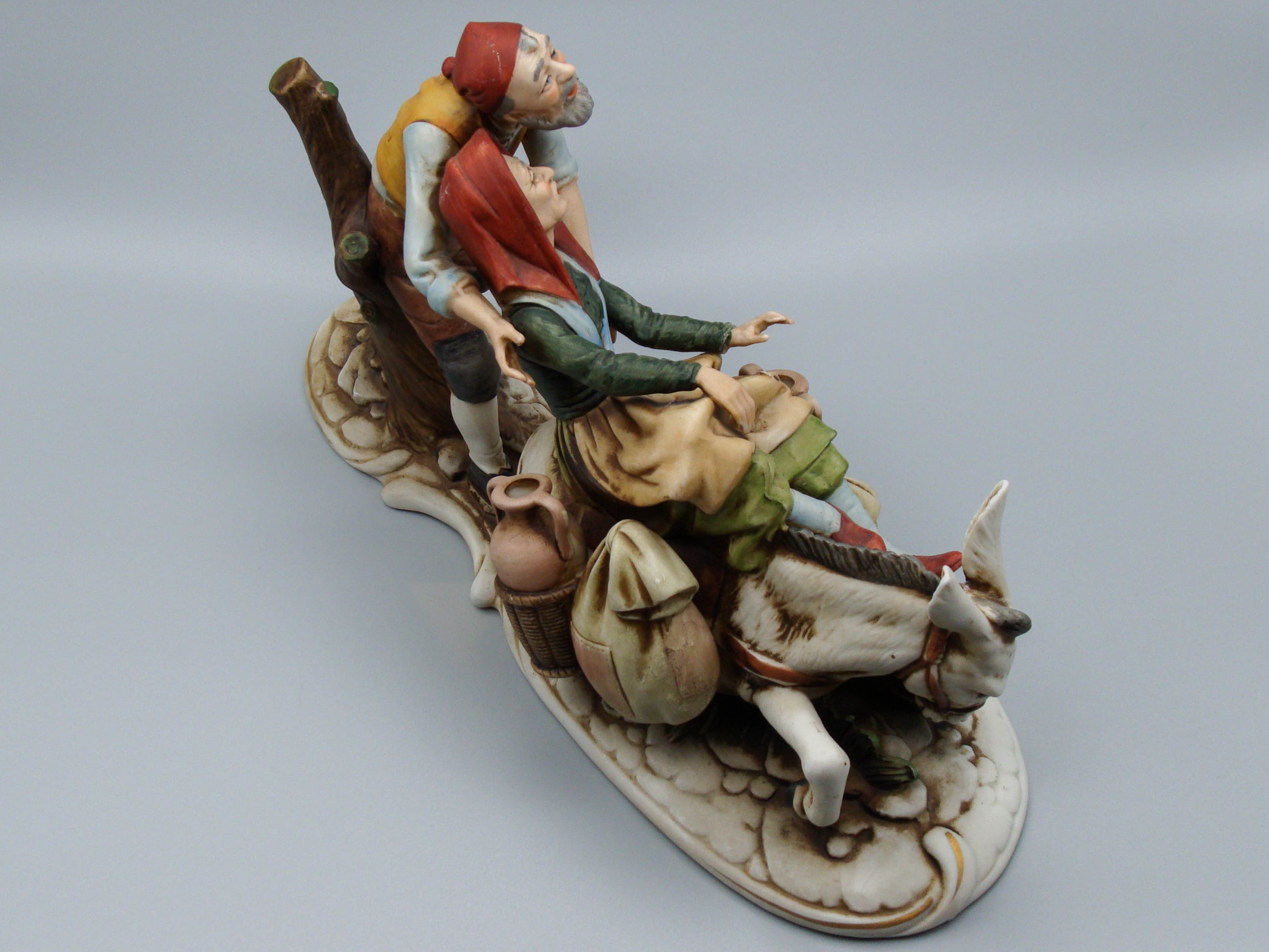 Merchant pair with donkey porcelain figurine