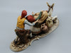 Merchant pair with donkey porcelain figurine