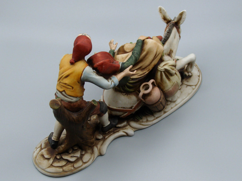 Merchant pair with donkey porcelain figurine