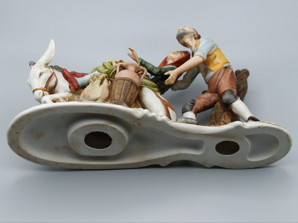 Merchant pair with donkey porcelain figurine